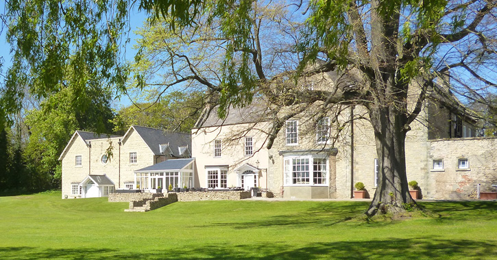 View of Hall Garth Hotel and surrounding park land on a sunny day